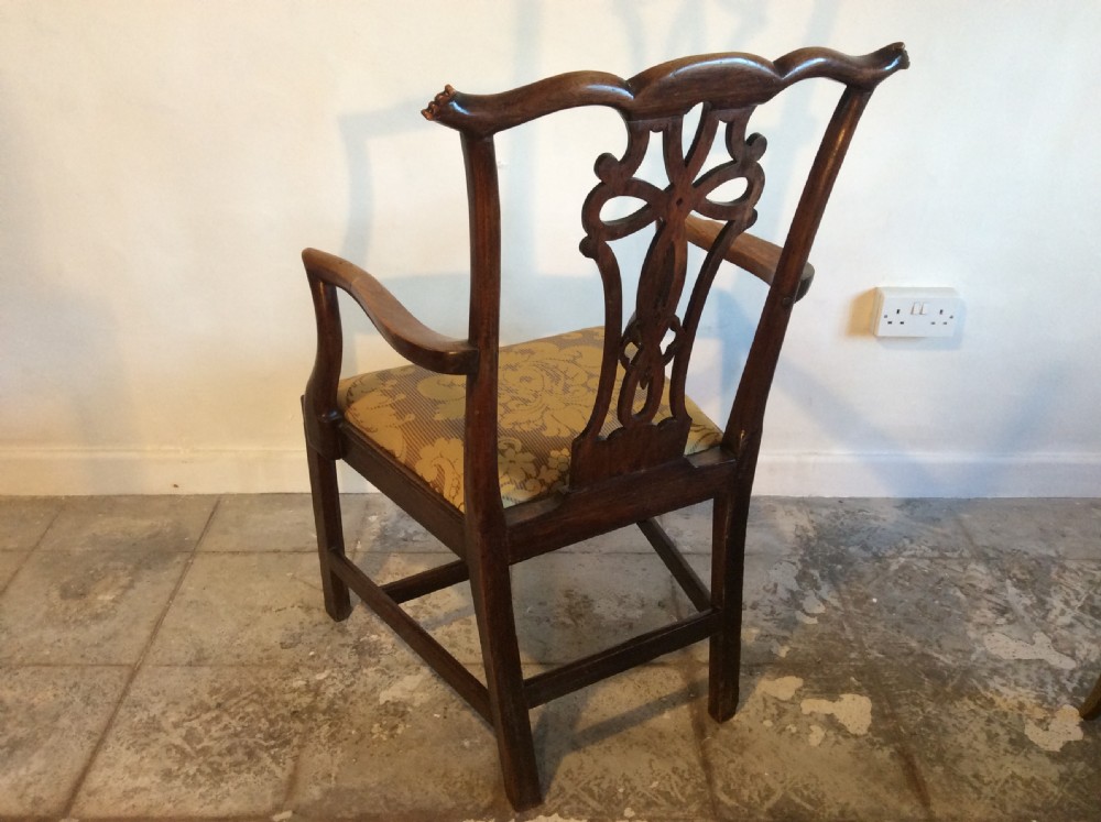 A Georgian George III elm open armchair featuring a pierced strapwork splat back, curved armrests, and a patterned upholstered seat. View X