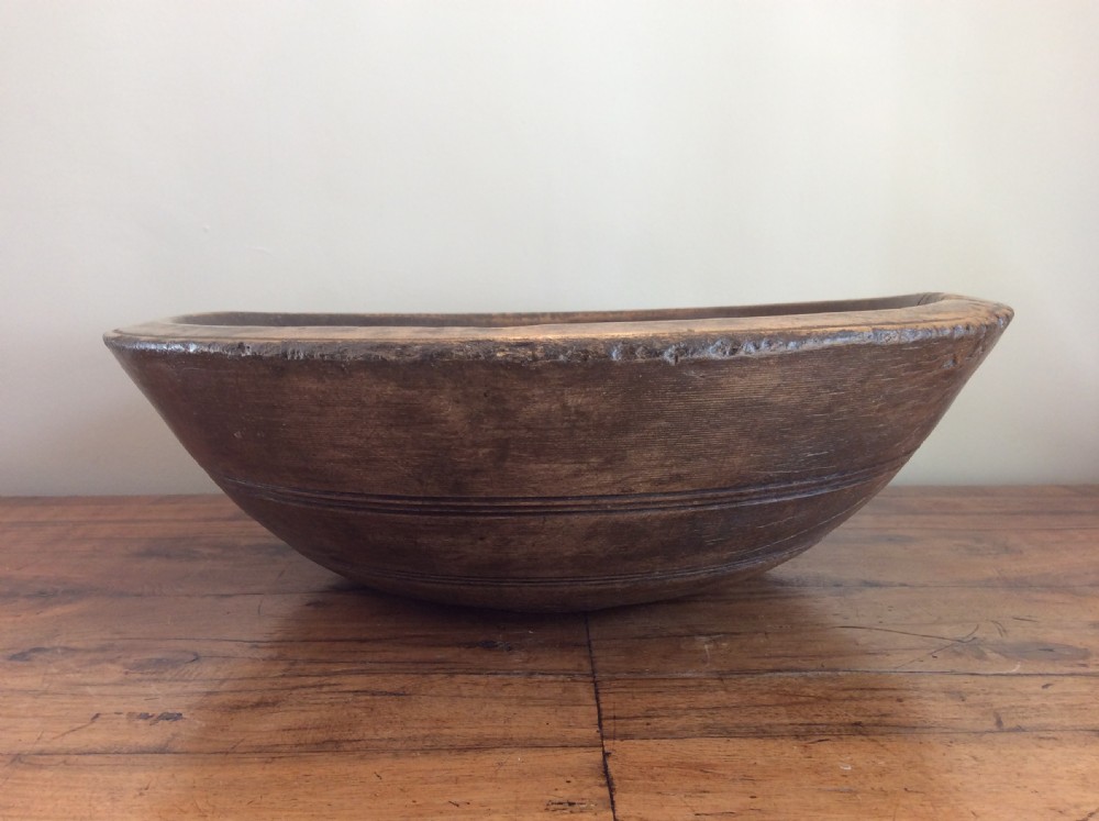 A large antique sycamore dairy bowl