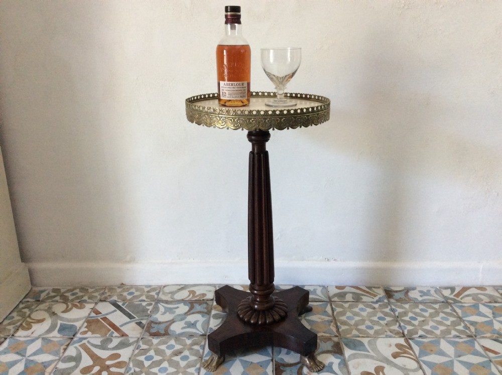 A circular French occasional table featuring a brass gallery, a reeded dark wood pedestal, and a four-point base with brass paw feet. View II