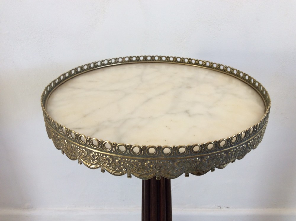 A circular French occasional table featuring a brass gallery, a reeded dark wood pedestal, and a four-point base with brass paw feet. View III