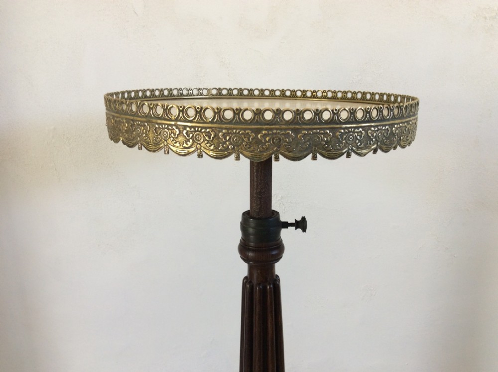 A circular French occasional table featuring a brass gallery, a reeded dark wood pedestal, and a four-point base with brass paw feet. View VII
