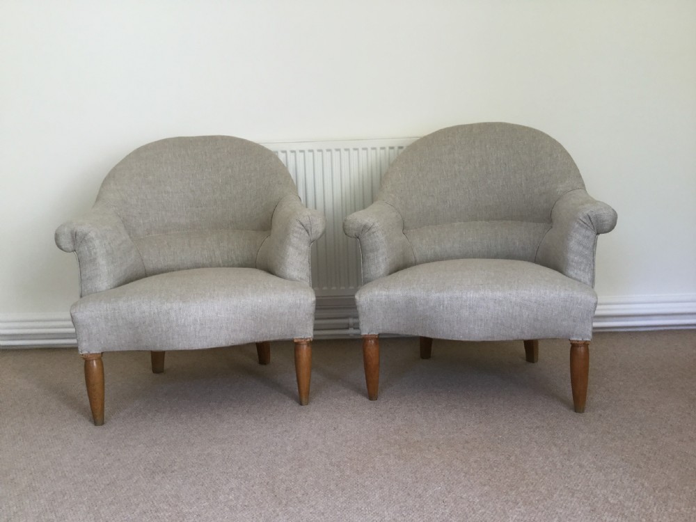A pair of French upholstered armchairs