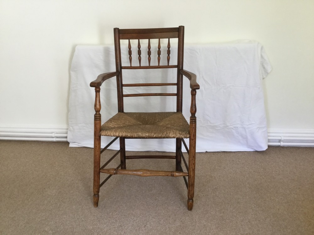 An 18thC rush seat spindle back chair