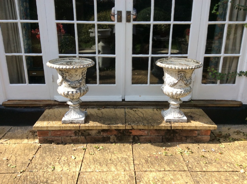 A pair of cast iron garden urns