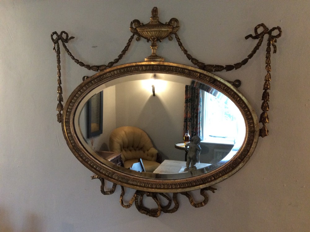 A small  gilded19thC Adams style mirror