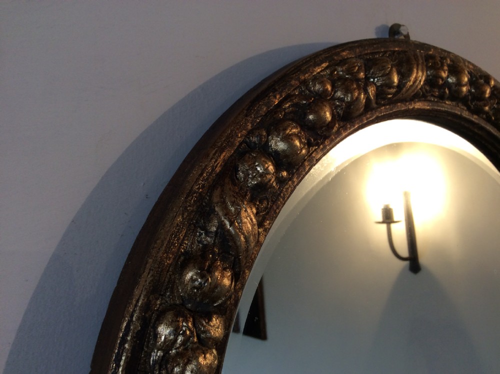 A gilded circular mirror View IV