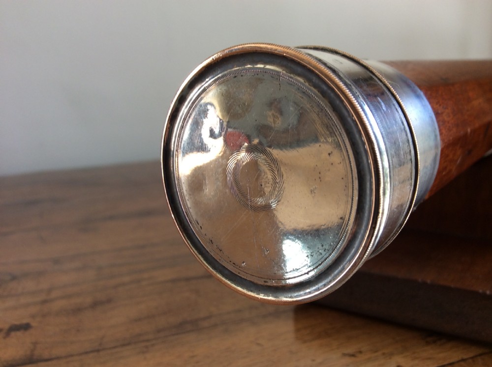 An 18th-century nine-sided mahogany and brass telescope resting on a matching wooden presentation stand. View VII
