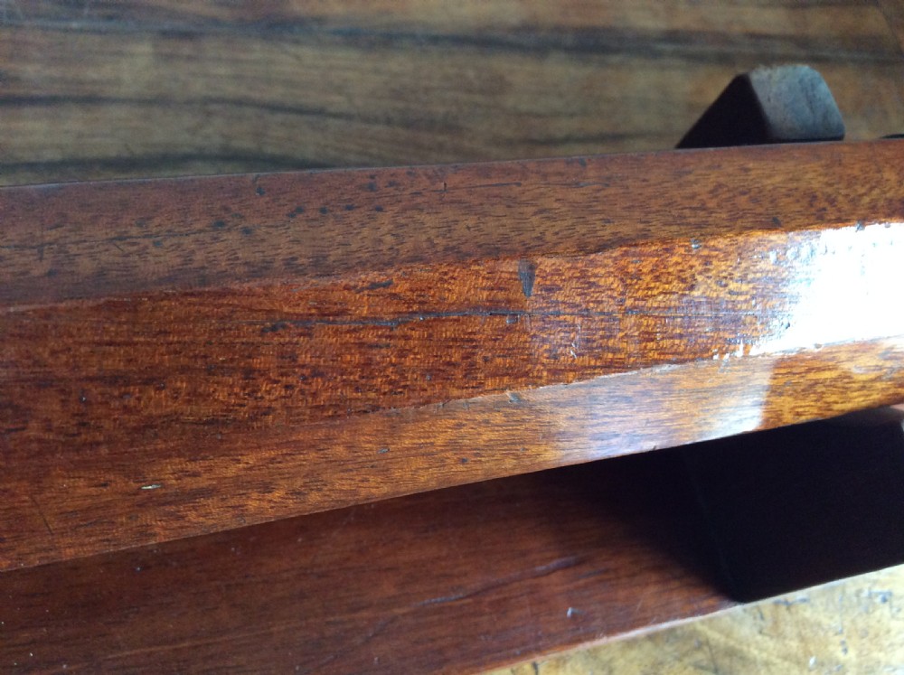 An 18th-century nine-sided mahogany and brass telescope resting on a matching wooden presentation stand. View XII