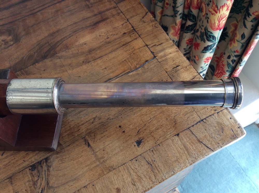 An 18th-century nine-sided mahogany and brass telescope resting on a matching wooden presentation stand. View XIII