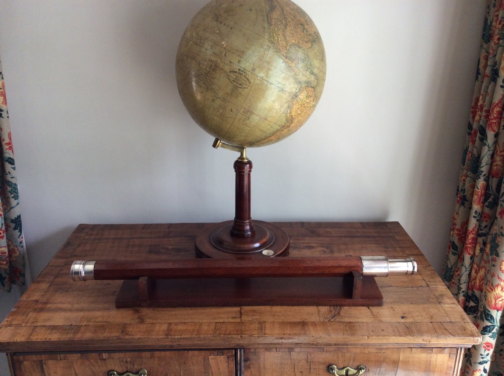 An 18th-century nine-sided mahogany and brass telescope resting on a matching wooden presentation stand. View XIV