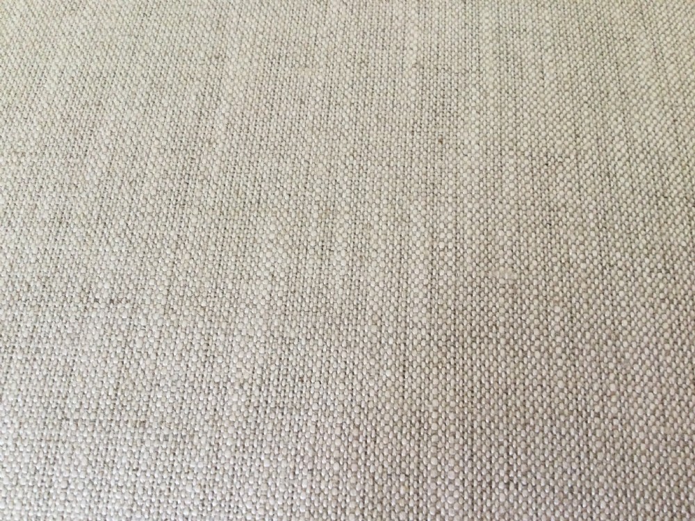 A 19th-century French upholstered footstool featuring cream linen fabric and turned wooden legs fitted with brass castors. View VI