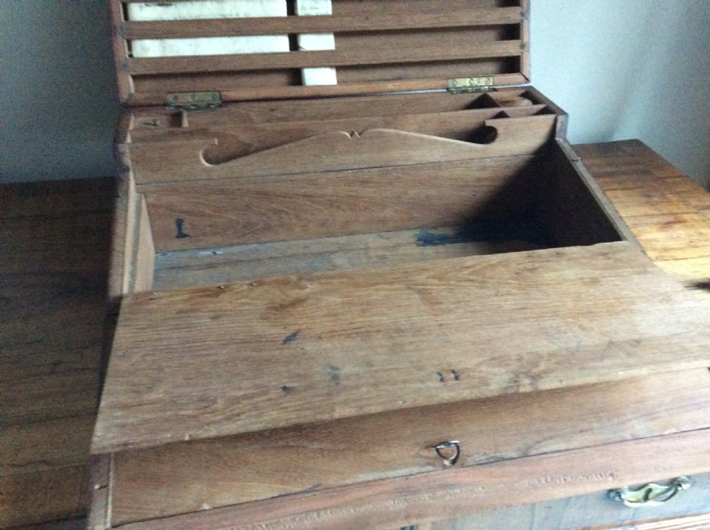 A rectangular warm brown teak campaign writing box featuring flush brass strapwork on the corners and a central decorative brass keyhole escutcheon. View IX