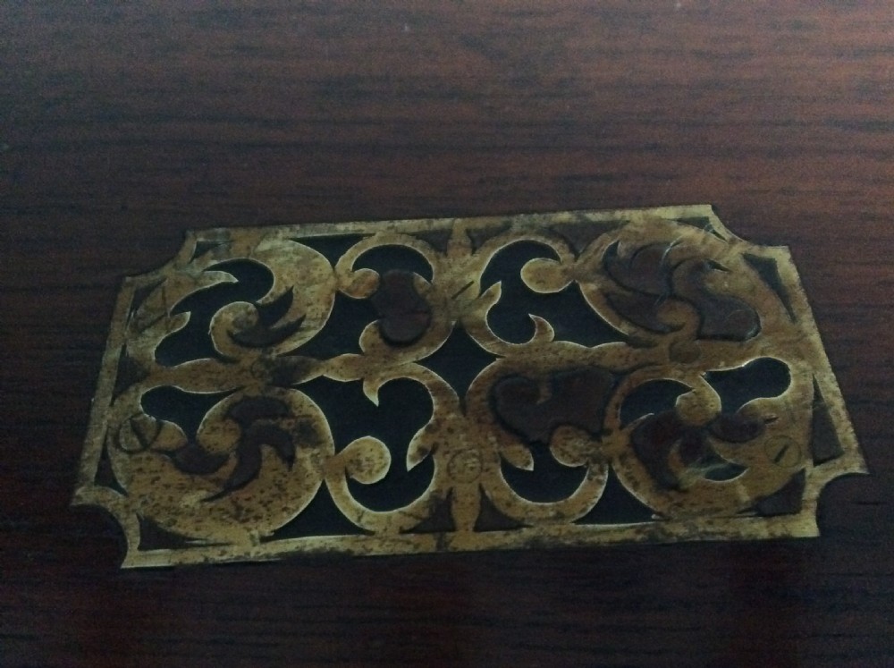 A rectangular warm brown teak campaign writing box featuring flush brass strapwork on the corners and a central decorative brass keyhole escutcheon. View XVII
