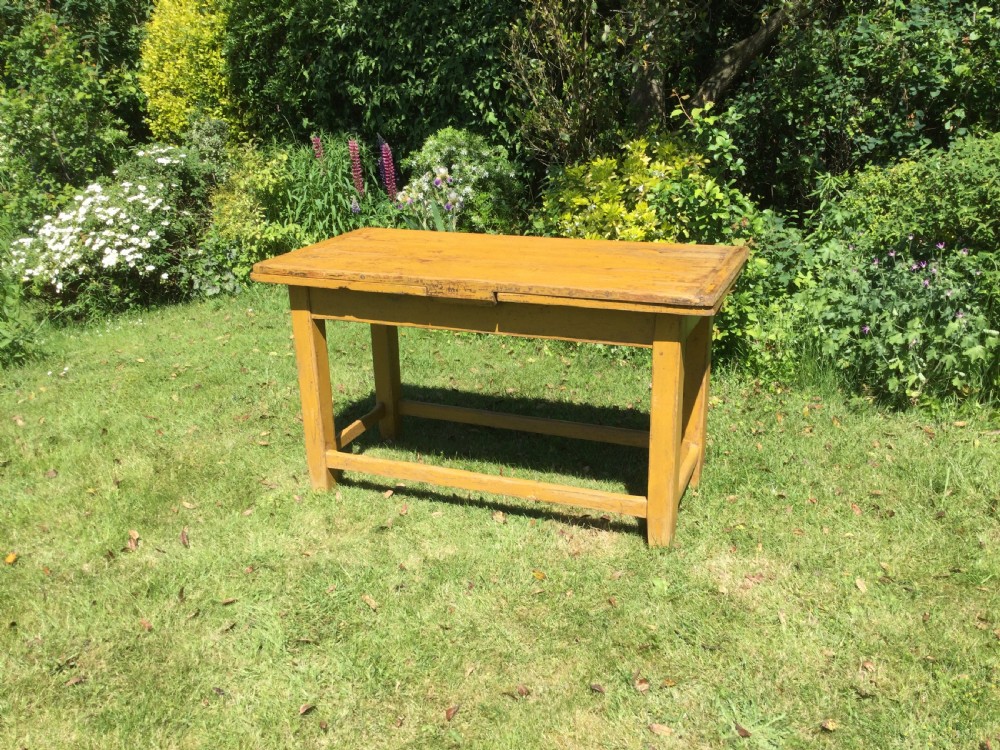 A rectangular warm pine farmhouse kitchen table featuring two end extension leaves supported by a sturdy square-legged stretcher base. View II