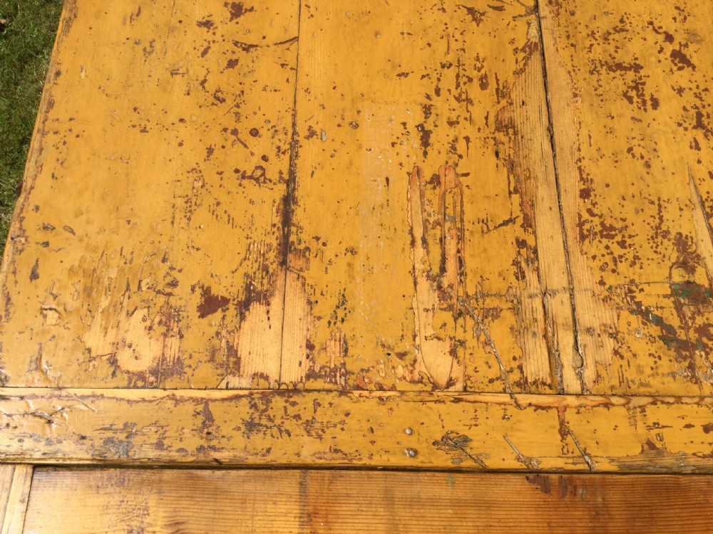 A rectangular warm pine farmhouse kitchen table featuring two end extension leaves supported by a sturdy square-legged stretcher base. View VII