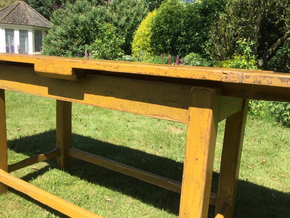 A rectangular warm pine farmhouse kitchen table featuring two end extension leaves supported by a sturdy square-legged stretcher base. View IX