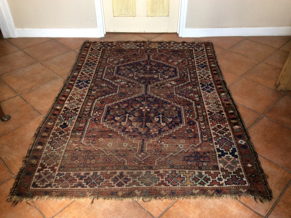 An antique 173cm x 122 Caucasian rug