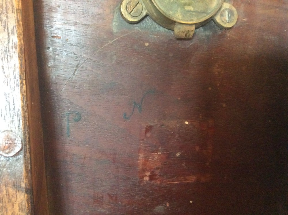 A George III mahogany tilt-top wine table with a circular dished top shown vertically above a turned column and tripod cabriole legs. View XII