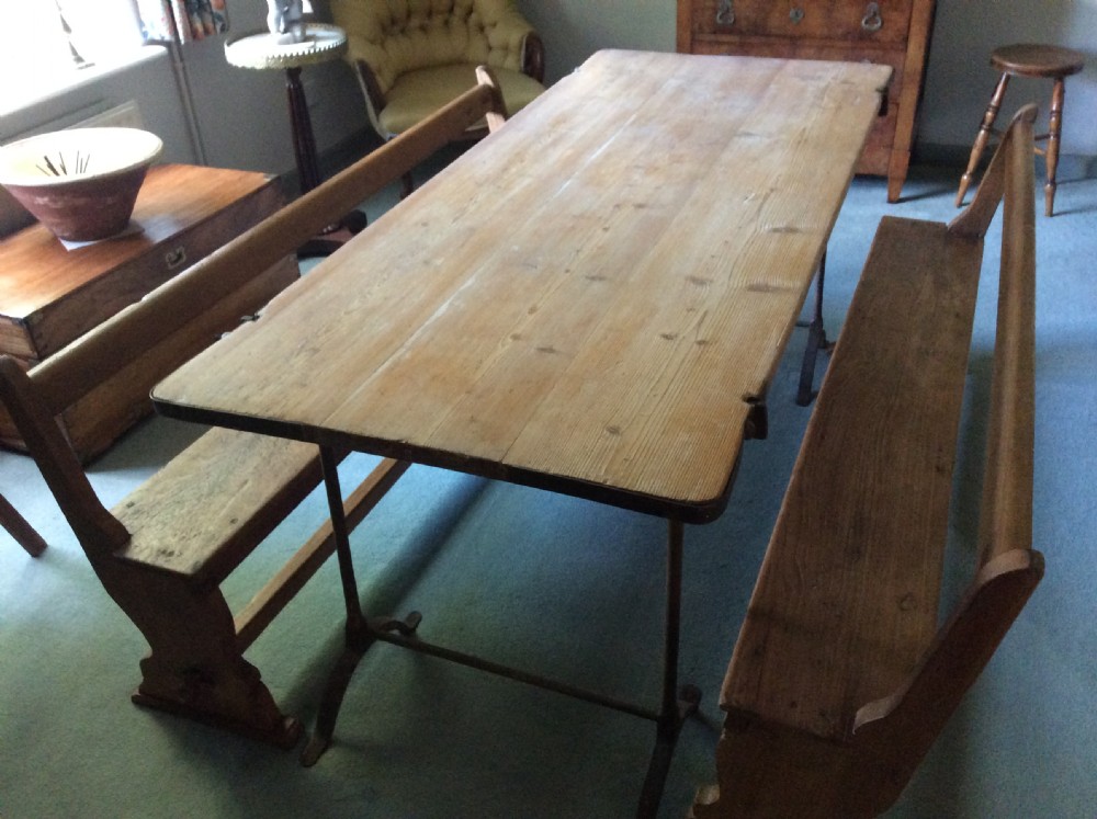 A pair of matching warm brown timber benches featuring low backrests, shaped side supports, and lower stretchers. View XII