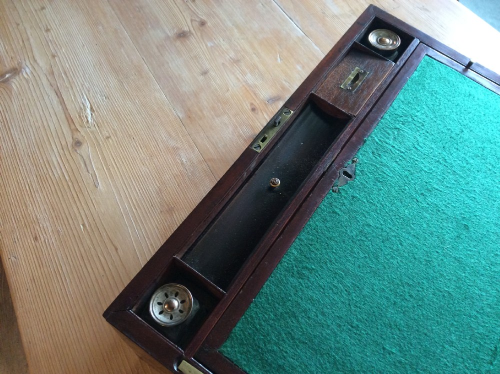 A rectangular mahogany campaign writing slope with flush brass corner brackets, brass straps, and a decorative brass keyhole escutcheon. View IX