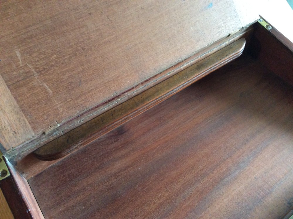 A rectangular mahogany campaign writing slope with flush brass corner brackets, brass straps, and a decorative brass keyhole escutcheon. View XI