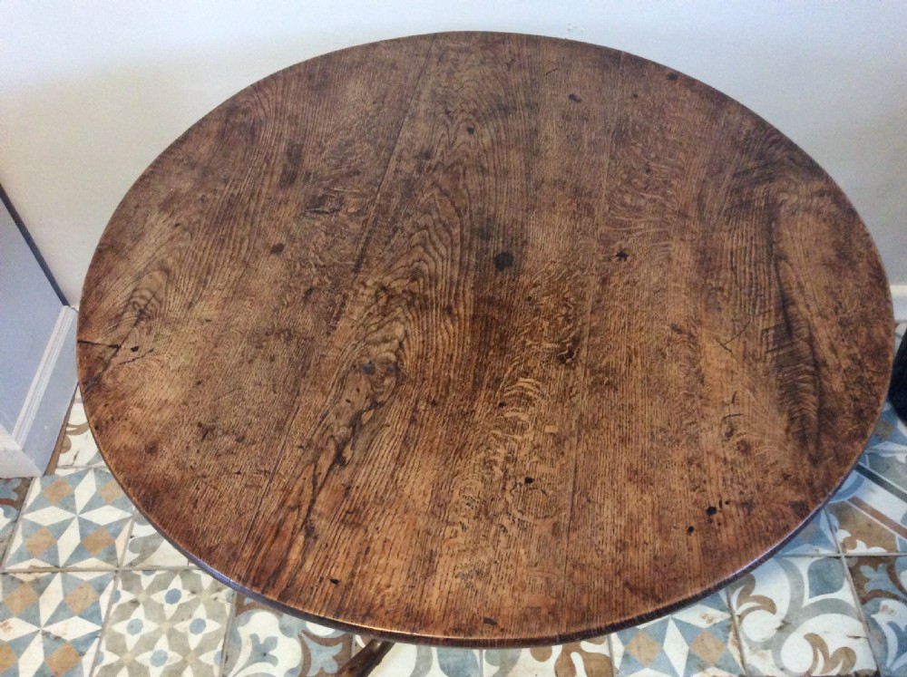 A Georgian oak and elm tilt top tripod table View III