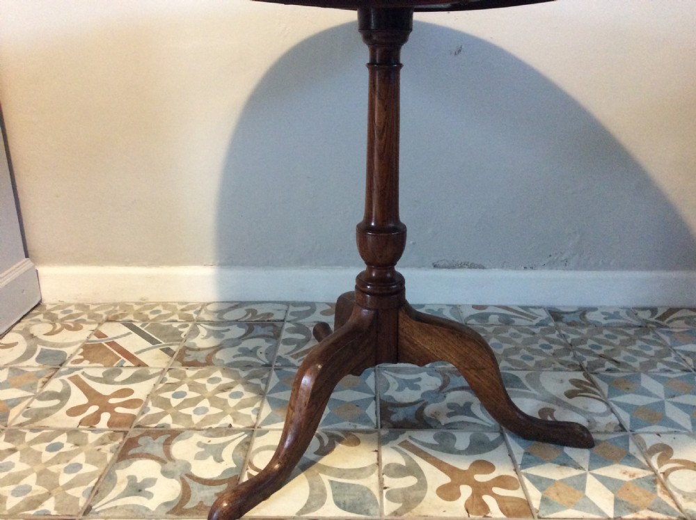 A Georgian oak and elm tilt top tripod table View V