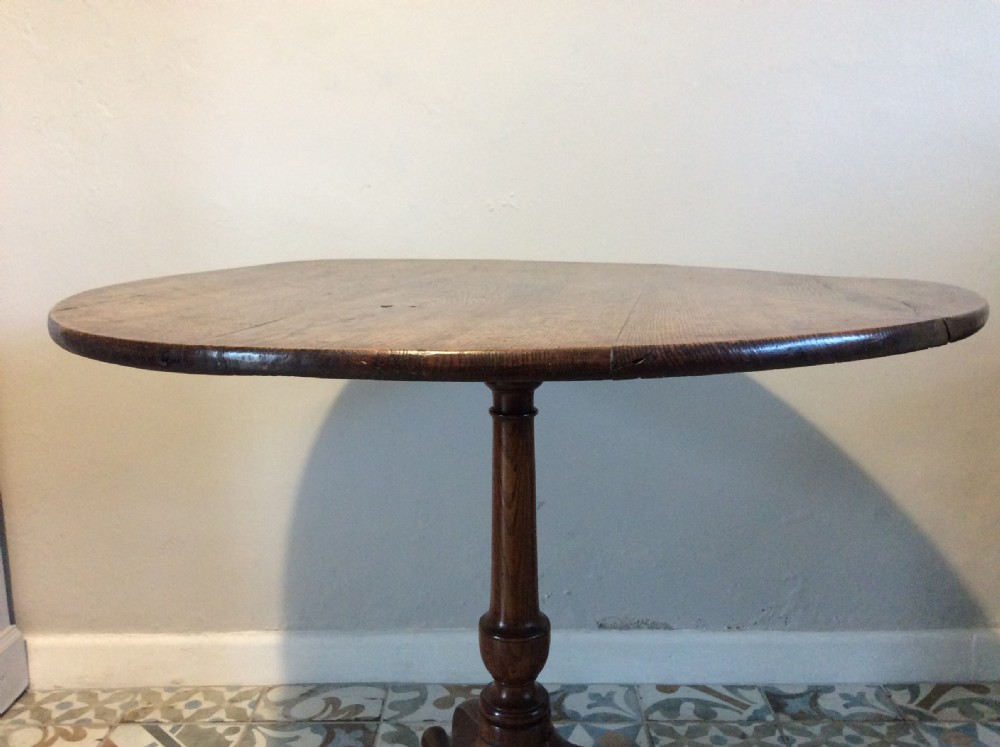 A Georgian oak and elm tilt top tripod table View VII