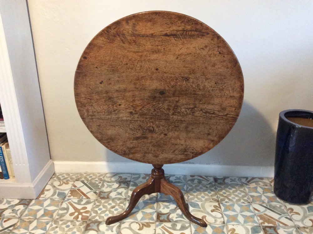 A Georgian oak and elm tilt top tripod table View IX