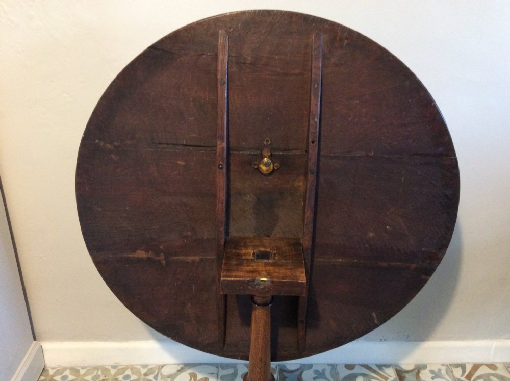 A Georgian oak and elm tilt top tripod table View XII