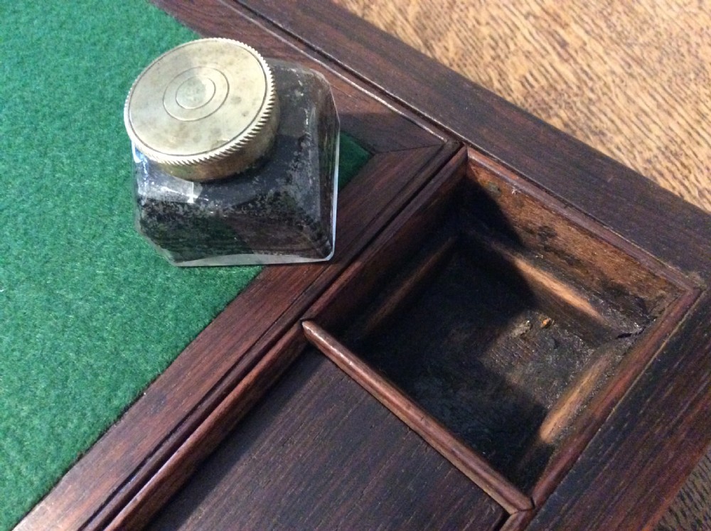 A closed 19th-century dark mahogany campaign writing slope with flush brass side handles and a brass escutcheon with key. View VI