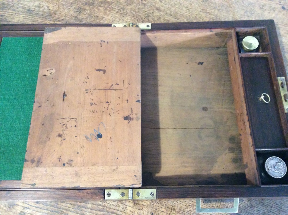 A closed 19th-century dark mahogany campaign writing slope with flush brass side handles and a brass escutcheon with key. View IX