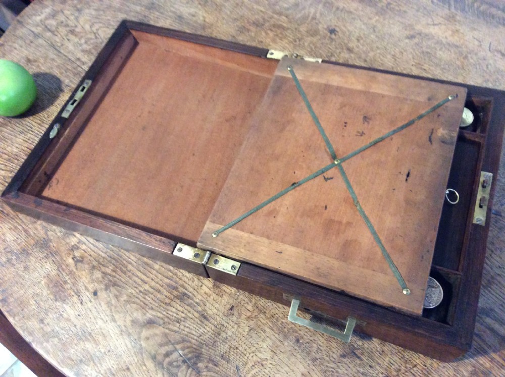A closed 19th-century dark mahogany campaign writing slope with flush brass side handles and a brass escutcheon with key. View XII