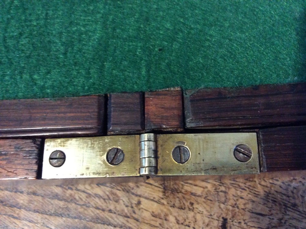 A closed 19th-century dark mahogany campaign writing slope with flush brass side handles and a brass escutcheon with key. View XIII