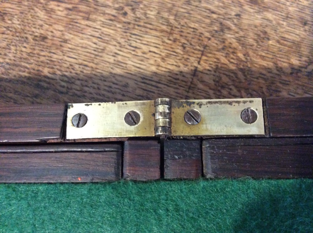 A closed 19th-century dark mahogany campaign writing slope with flush brass side handles and a brass escutcheon with key. View XIV