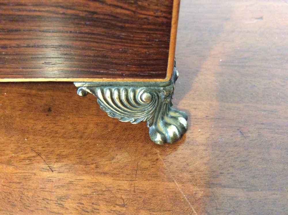 An open rectangular dark rosewood jewellery box featuring a diamond-shaped bone escutcheon, brass claw feet, and a dark lined interior. View IV