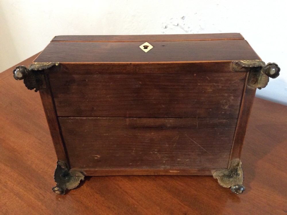 An open rectangular dark rosewood jewellery box featuring a diamond-shaped bone escutcheon, brass claw feet, and a dark lined interior. View XIV