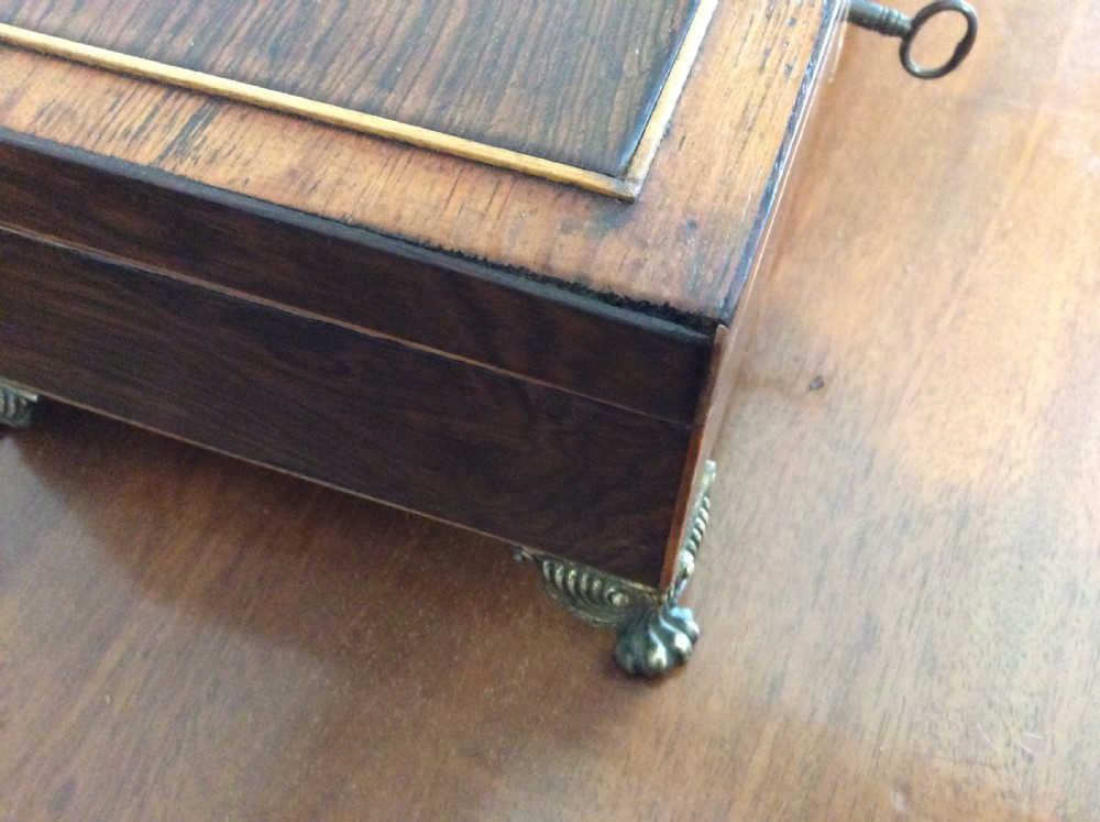 An open rectangular dark rosewood jewellery box featuring a diamond-shaped bone escutcheon, brass claw feet, and a dark lined interior. View XV