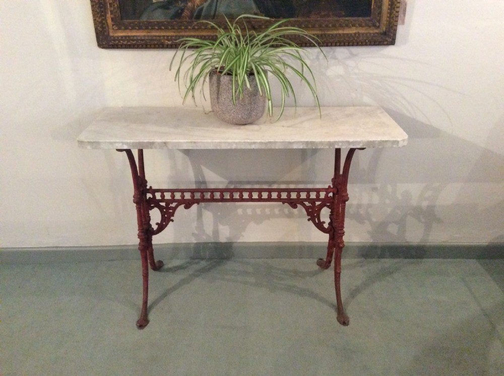 A cast iron and marble console hall table