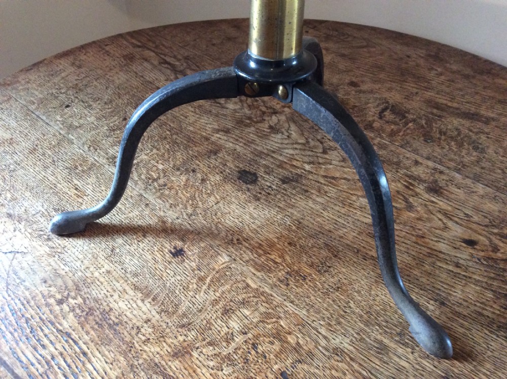 A nineteenth-century brass terrestrial library telescope supported by a dark tripod stand. View III