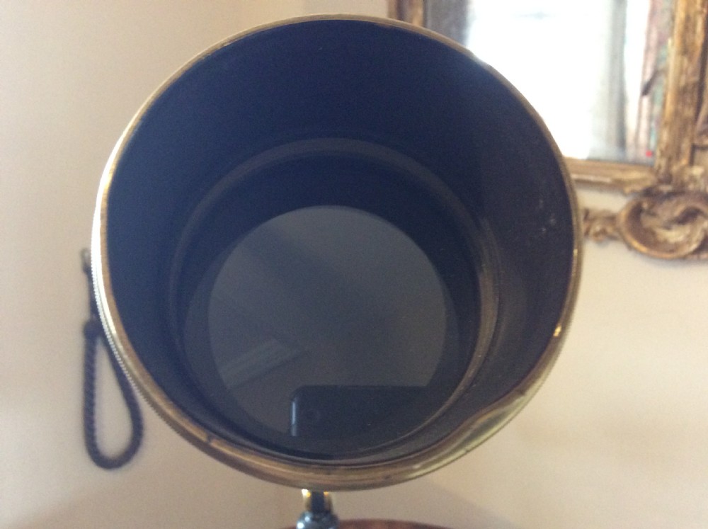 A nineteenth-century brass terrestrial library telescope supported by a dark tripod stand. View VI