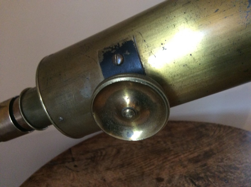 A nineteenth-century brass terrestrial library telescope supported by a dark tripod stand. View VII