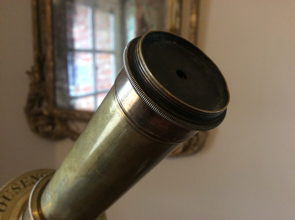 A nineteenth-century brass terrestrial library telescope supported by a dark tripod stand. View VIII