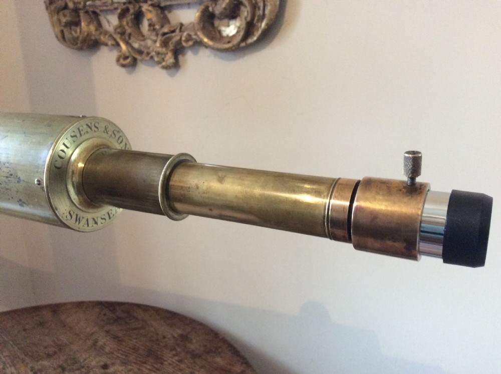 A nineteenth-century brass terrestrial library telescope supported by a dark tripod stand. View IX