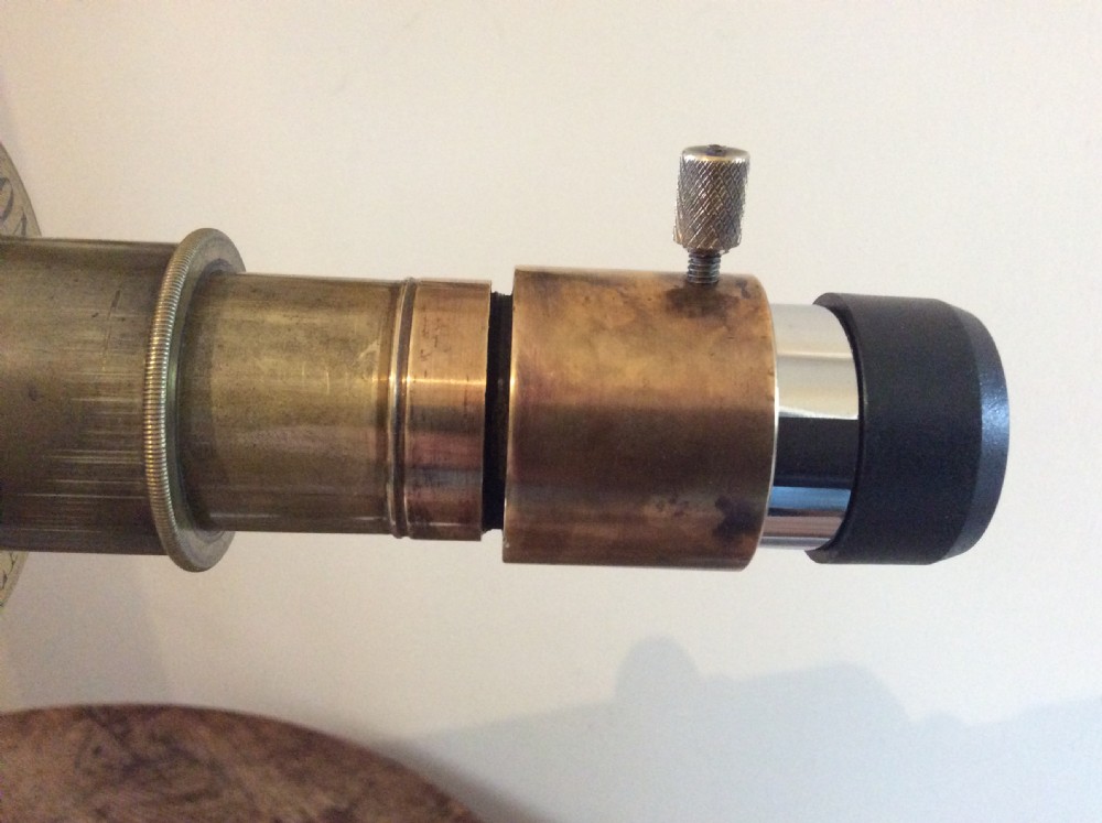 A nineteenth-century brass terrestrial library telescope supported by a dark tripod stand. View XII