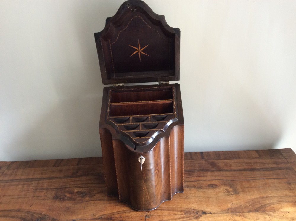 A Georgian mahogany knife box featuring a sloped hinged lid, serpentine front, boxwood stringing, and a metal keyhole escutcheon. View II