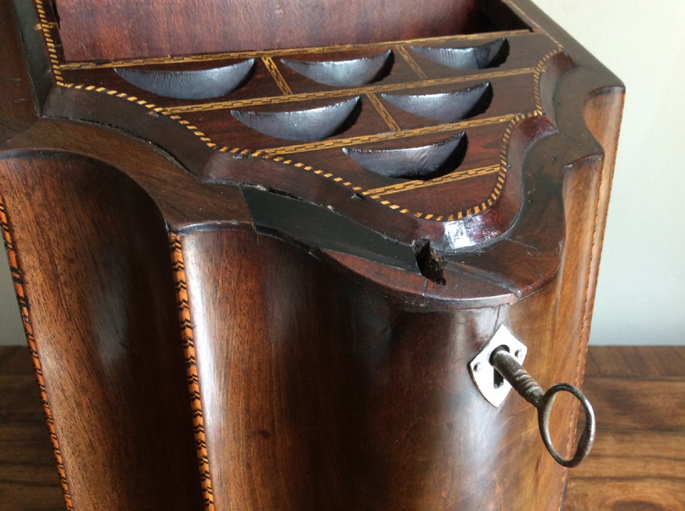 A Georgian mahogany knife box featuring a sloped hinged lid, serpentine front, boxwood stringing, and a metal keyhole escutcheon. View III
