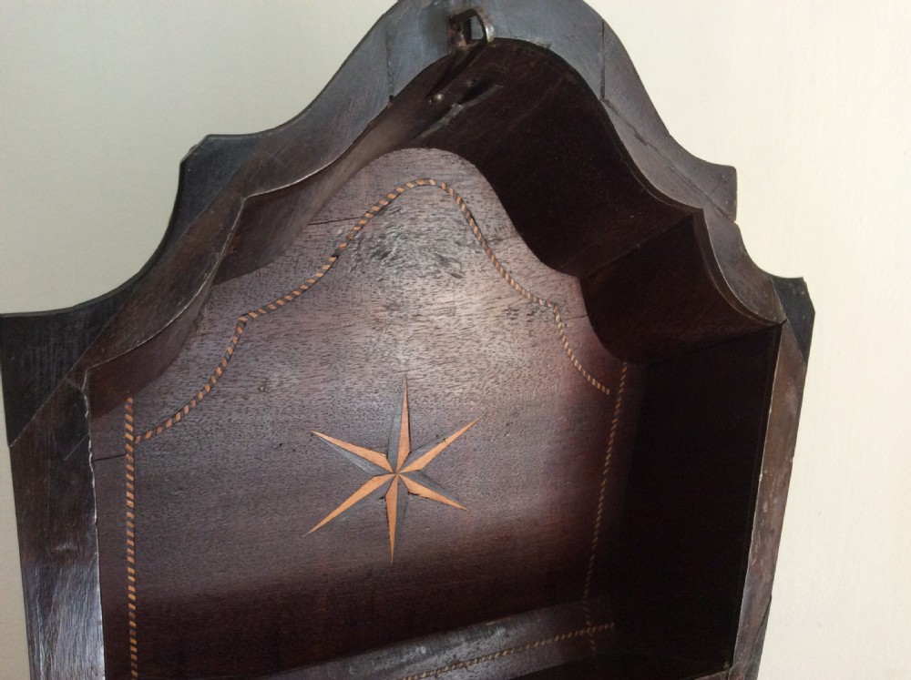 A Georgian mahogany knife box featuring a sloped hinged lid, serpentine front, boxwood stringing, and a metal keyhole escutcheon. View IV