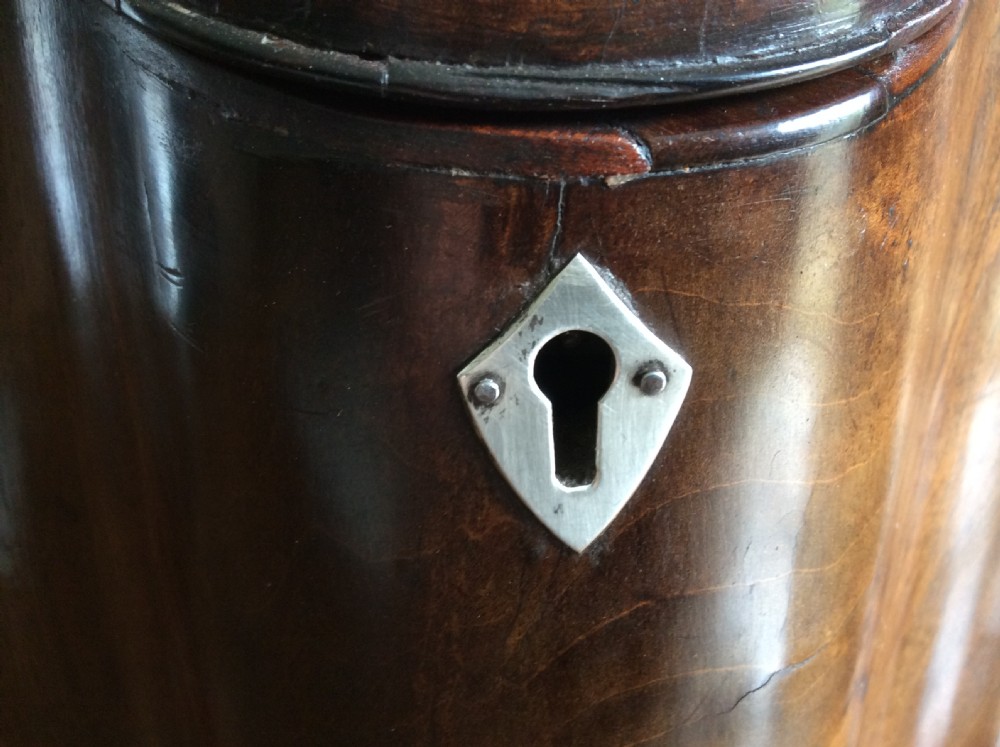 A Georgian mahogany knife box featuring a sloped hinged lid, serpentine front, boxwood stringing, and a metal keyhole escutcheon. View VI