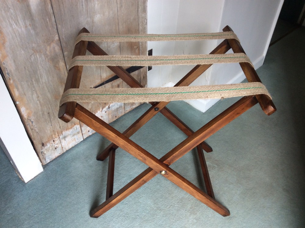 A nineteenth-century mahogany butlers tray featuring raised gallery sides with cut-out handles, resting on a folding X-frame wooden stand. View V